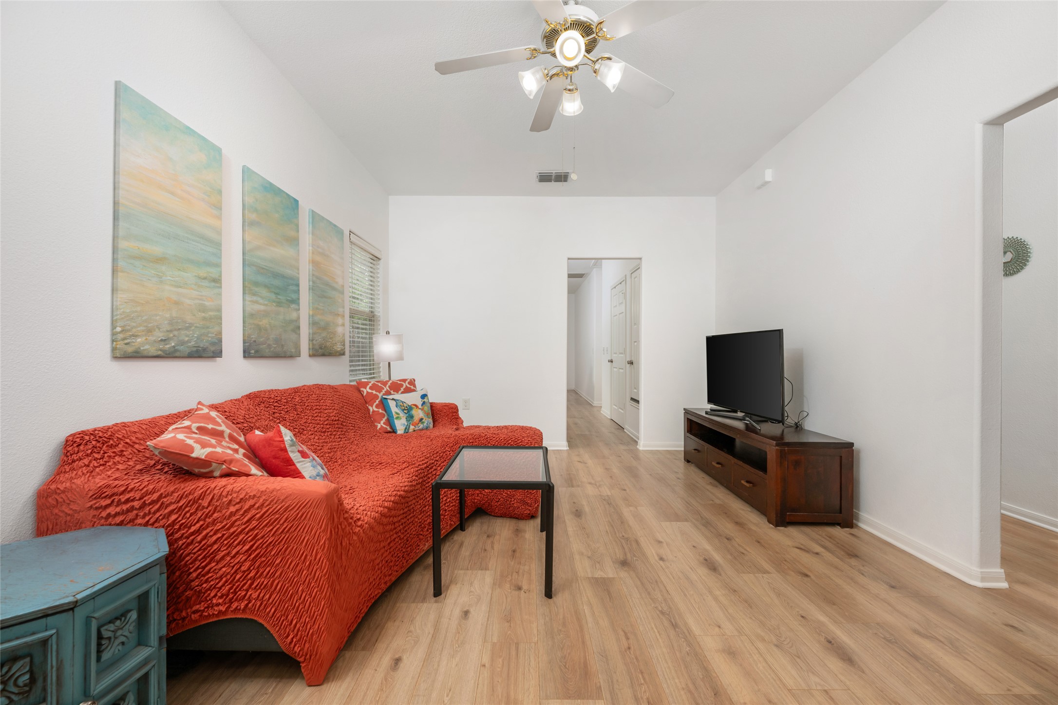 5613 Signal Point Austin, TX 78724 - Photo 5 of 21 Open concept living space featuring wood-finish flooring, white walls, and a ceiling fan with integrated lighting