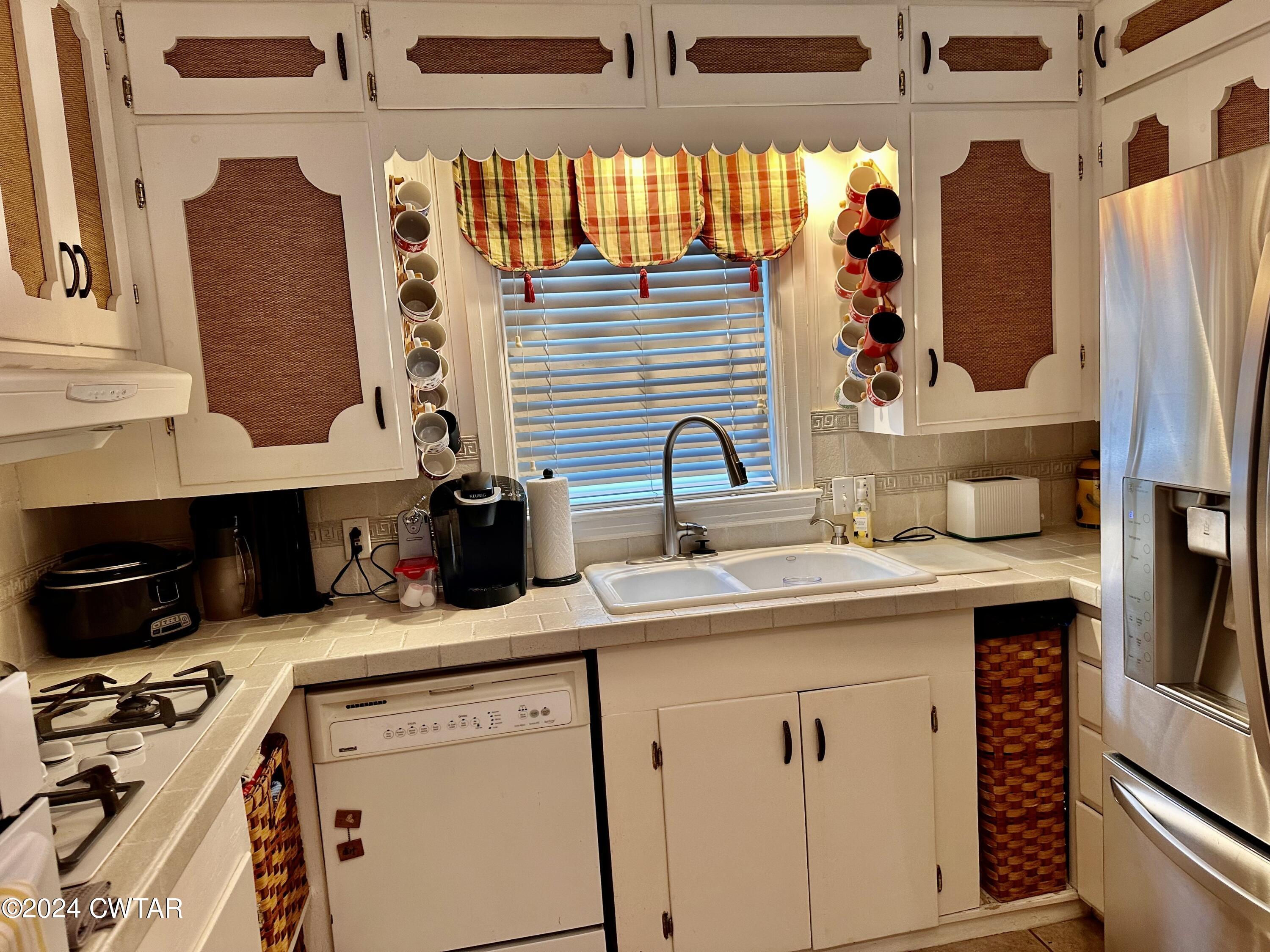 711 South Main Street Ridgely, TN 38080 - Photo 6 of 15 a kitchen with a sink and a refrigerator