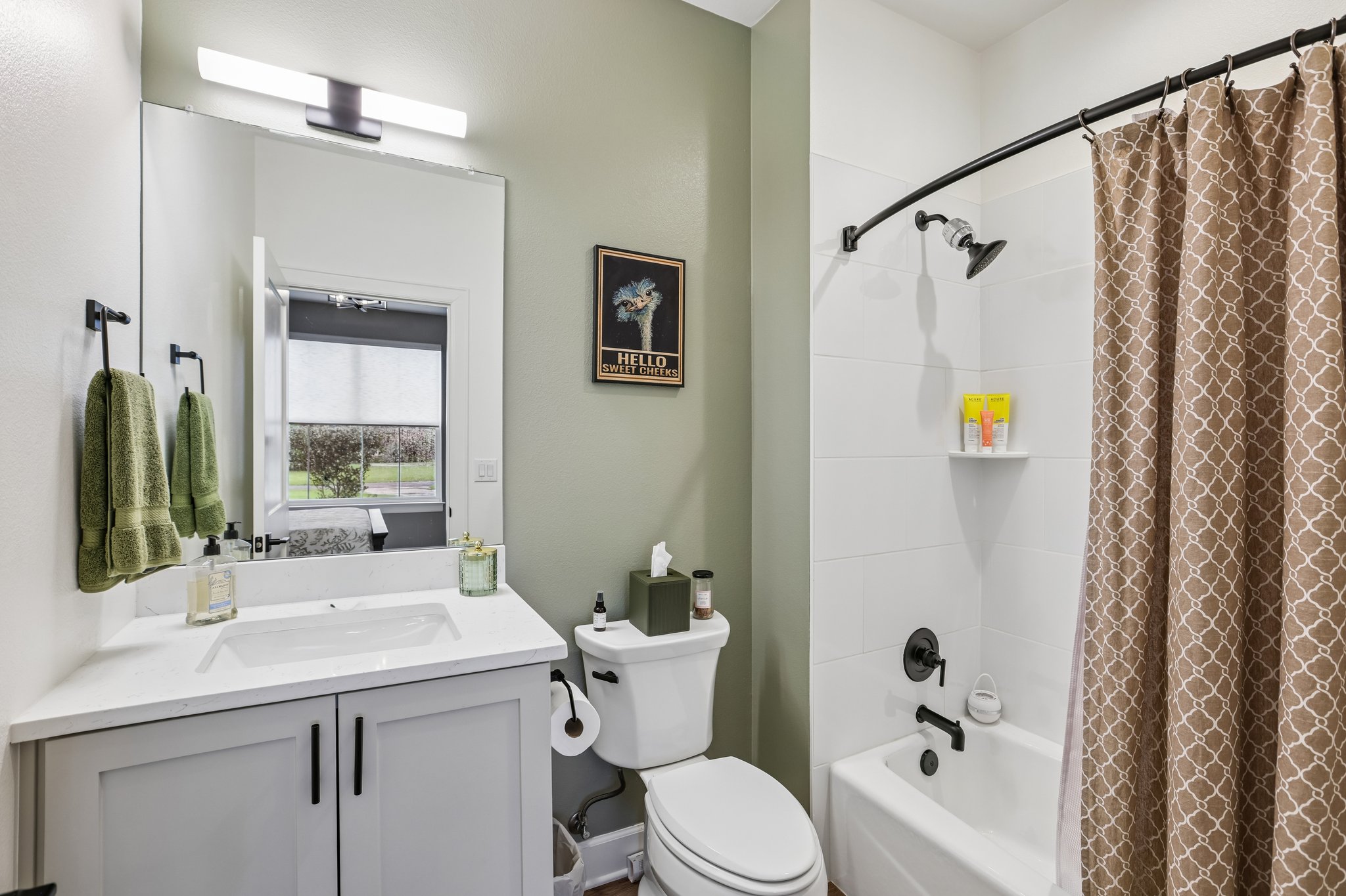 113 Crystal Lane Georgetown, TX 78633 - Photo 22 of 32 A well-appointed bathroom features a crisp white vanity and a full shower-tub combination.