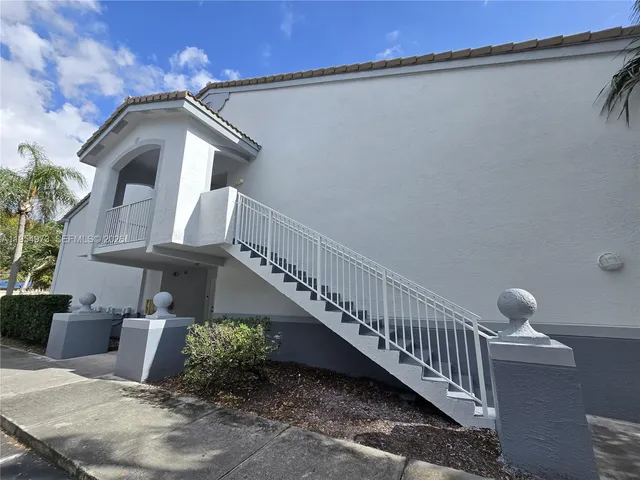 a balcony with table and chairs