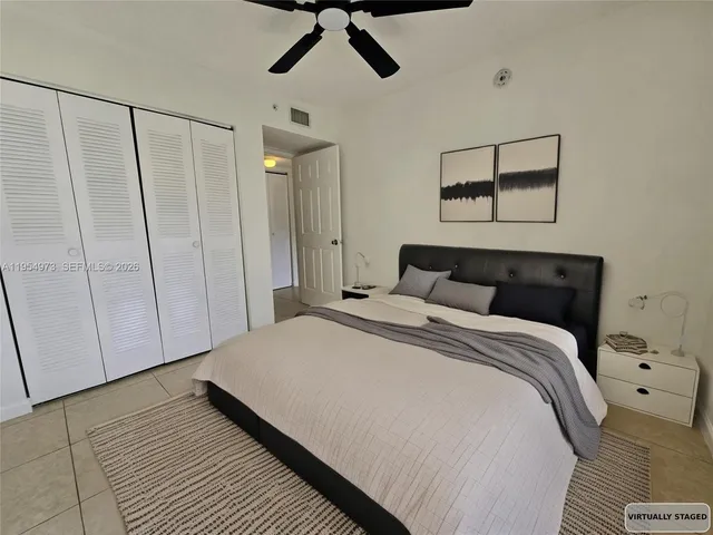 a bedroom with a bed and a mirror