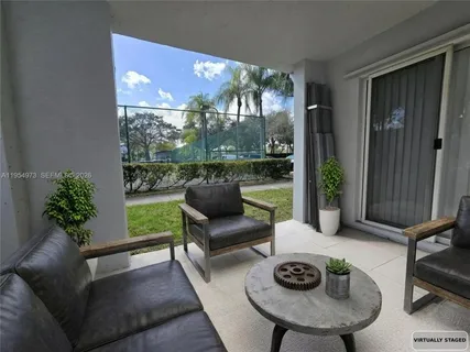 a living room with furniture and a floor to ceiling window