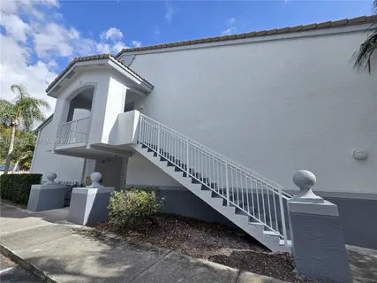 a balcony with table and chairs
