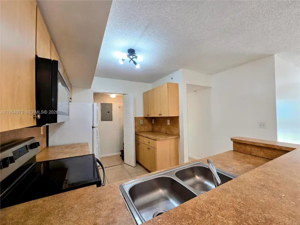 a kitchen with a sink stove and refrigerator
