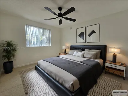 a bedroom with bed and window