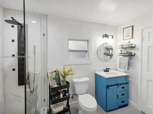 a kitchen with stainless steel appliances granite countertop a table chairs and a refrigerator