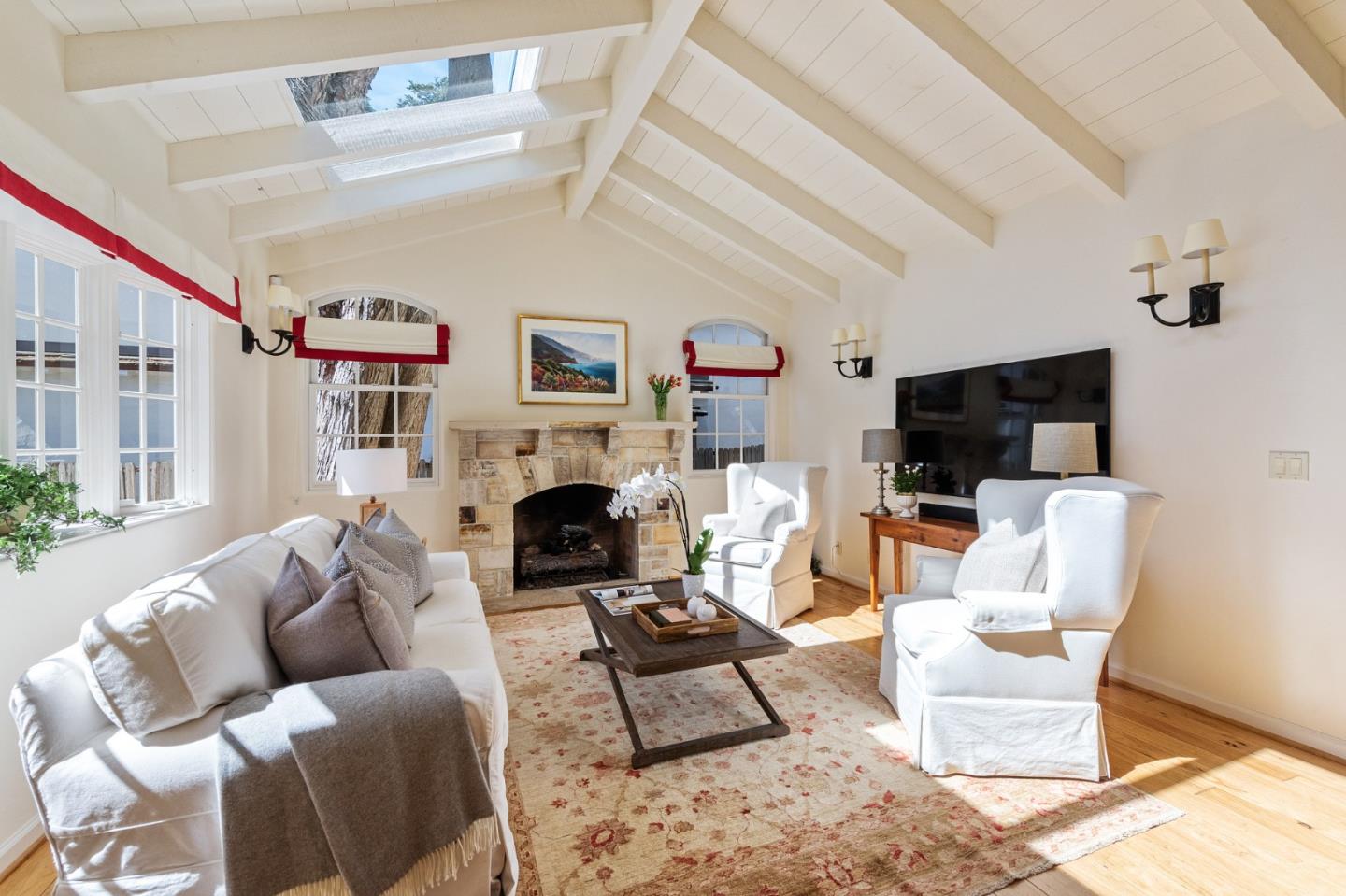 26335 Rio Avenue Carmel, CA 93923 - Photo 12 of 56 a living room with furniture a flat screen tv and a fireplace