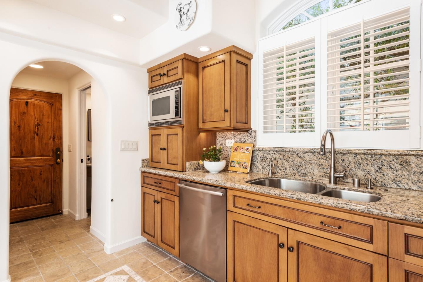 26335 Rio Avenue Carmel, CA 93923 - Photo 15 of 56 a kitchen with stainless steel appliances granite countertop a sink and a granite counter tops with a large window