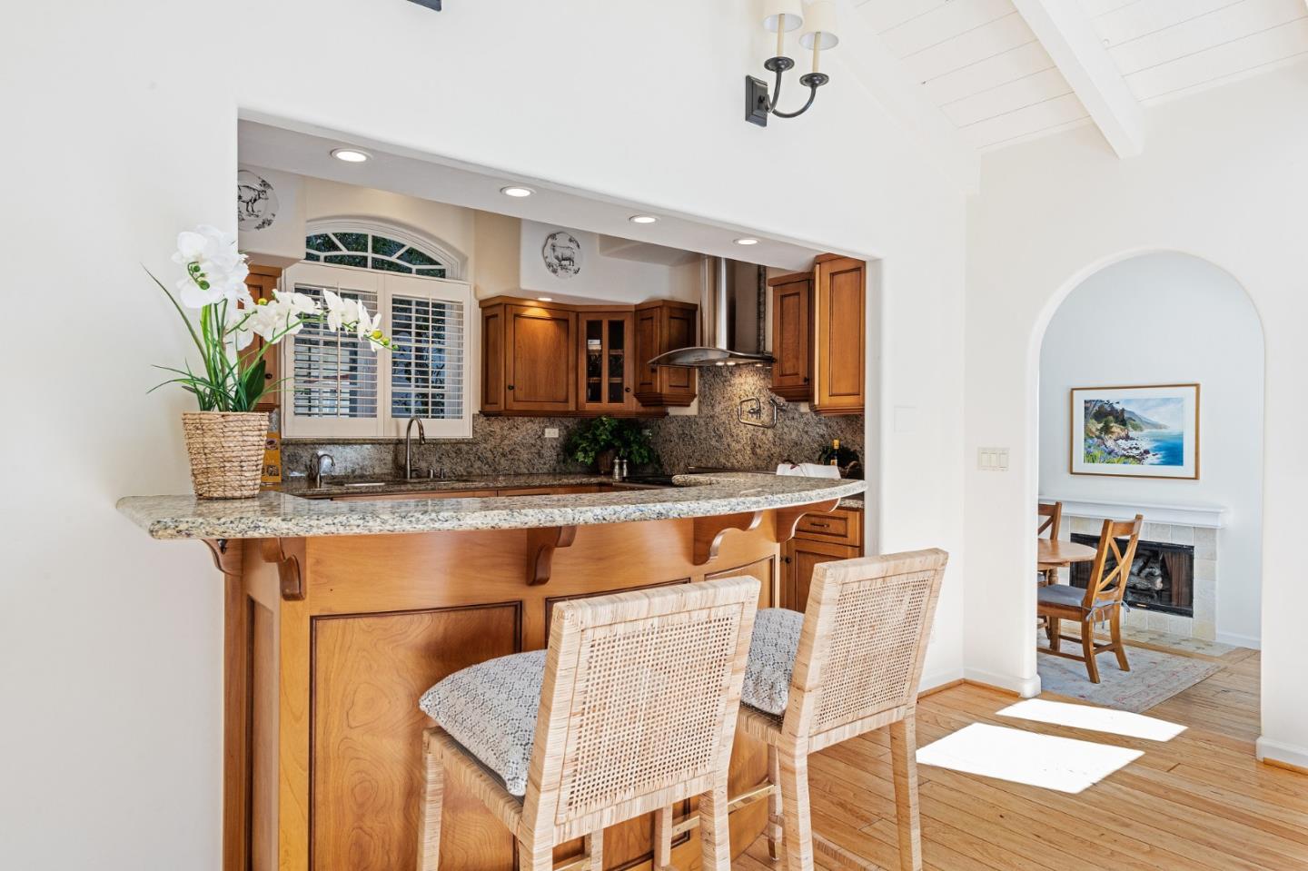 26335 Rio Avenue Carmel, CA 93923 - Photo 21 of 56 a living room with stainless steel appliances kitchen island granite countertop furniture and a wooden floor