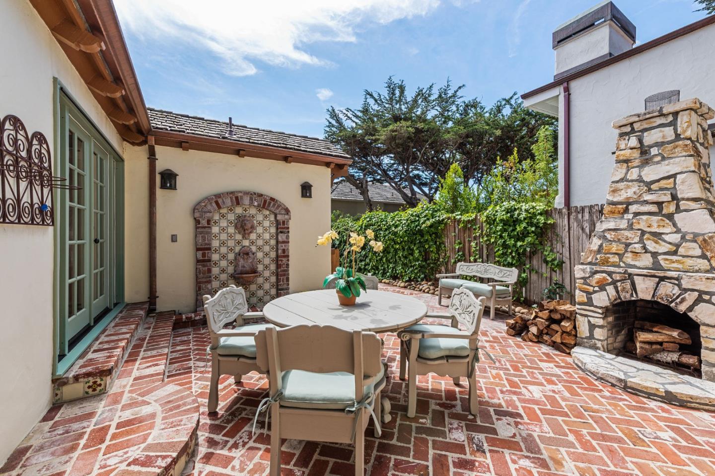 26335 Rio Avenue Carmel, CA 93923 - Photo 25 of 56 a view of a patio with table and chairs and potted plants