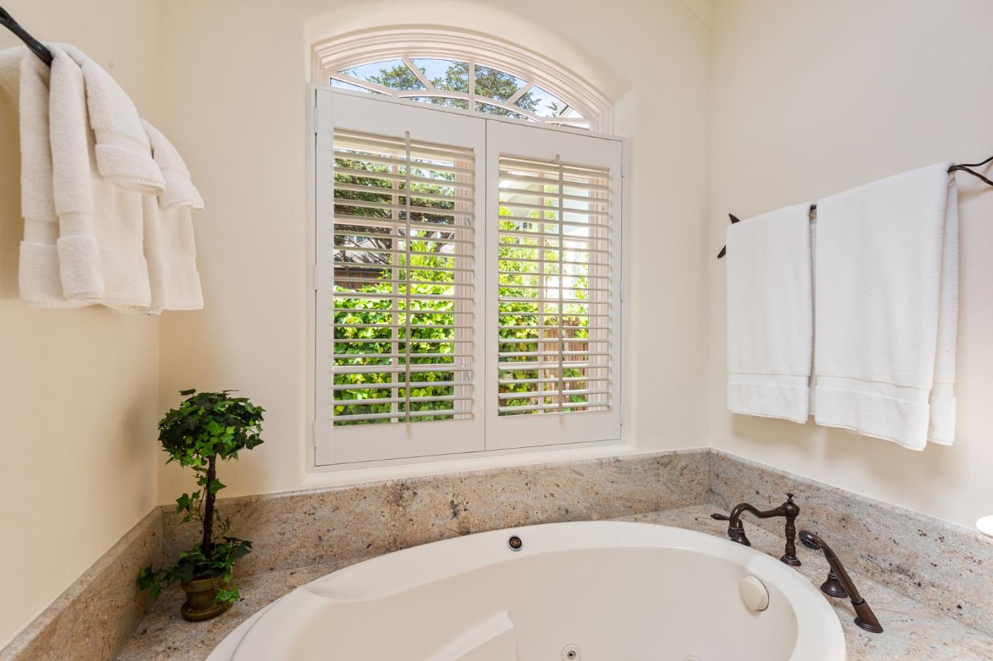 26335 Rio Avenue Carmel, CA 93923 - Photo 33 of 56 a white bath tub sitting in a bathroom next to a window