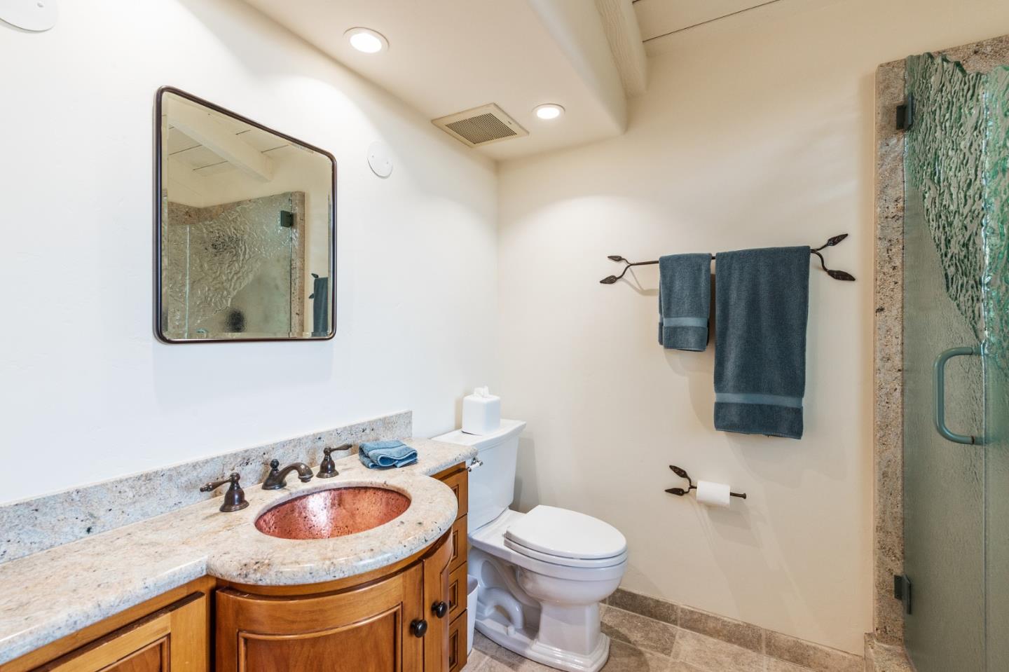 26335 Rio Avenue Carmel, CA 93923 - Photo 44 of 56 a bathroom with a toilet sink and mirror