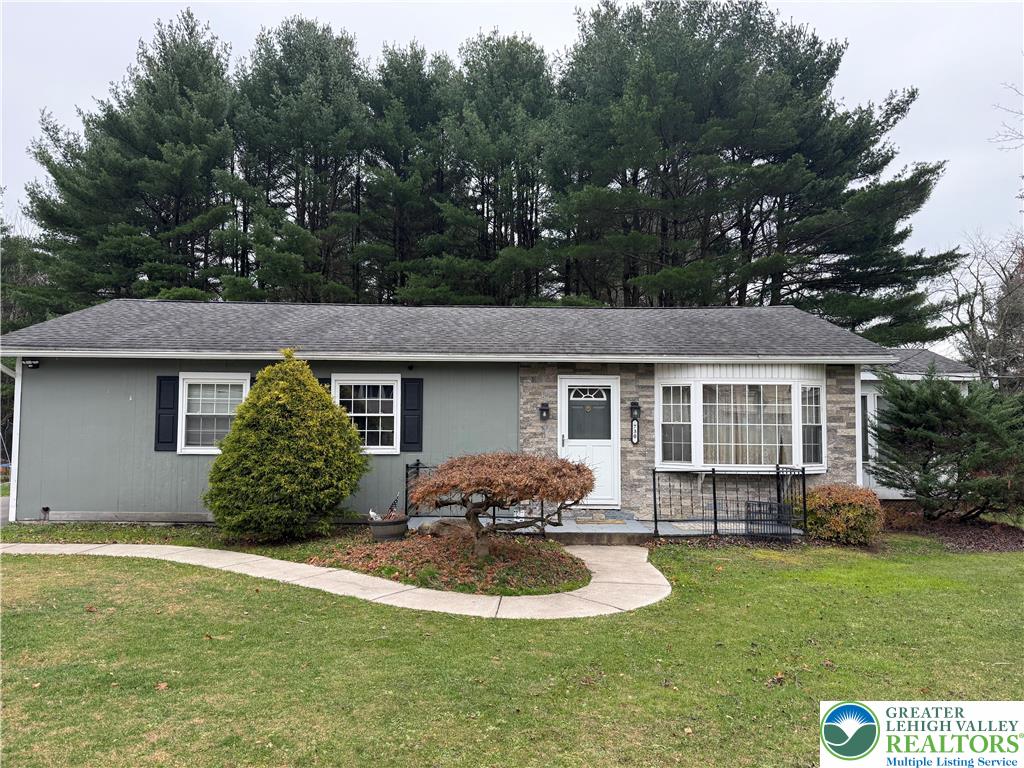 a front view of a house with a yard and porch