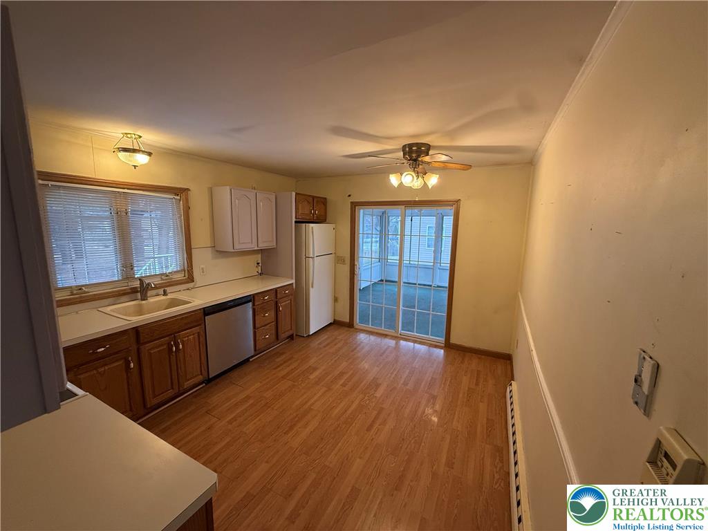 730 East Main Street Weatherly, PA 18255 - Photo 8 of 16 a large kitchen with wooden floors and stainless steel appliances