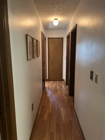 a view of hallway with wooden floor
