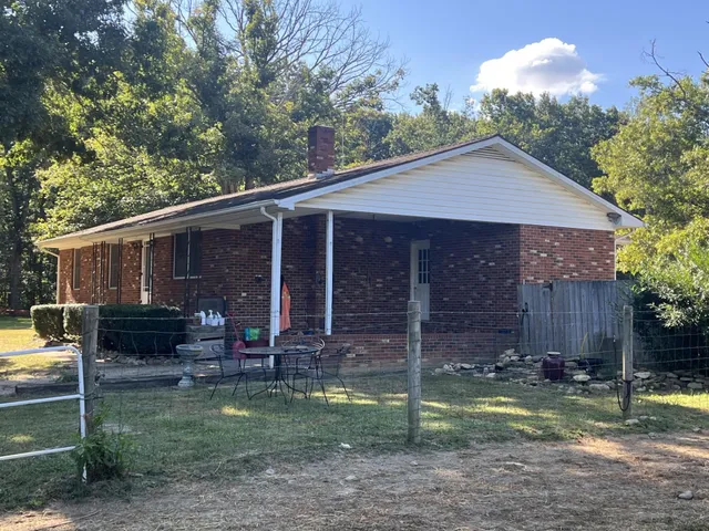 a view of a house with backyard tub and sitting area