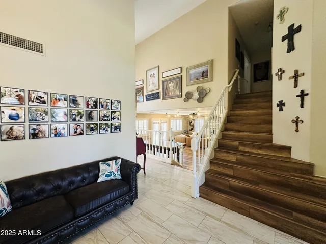 a living room with furniture and stairs