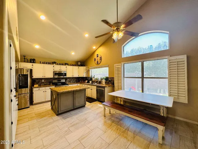 a kitchen with a refrigerator and a stove top oven