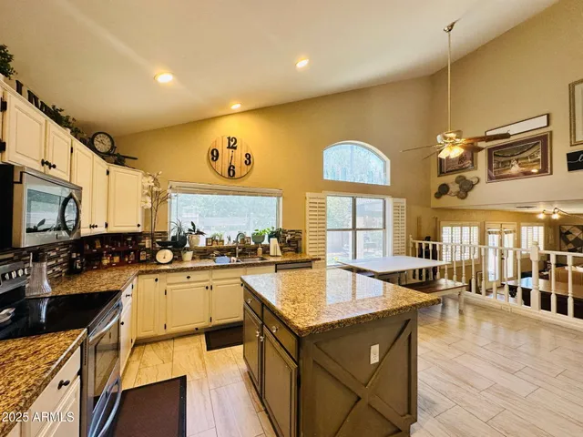 a large kitchen with lots of counter space and stainless steel appliances