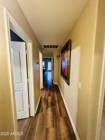 a view of gallery with wooden floor