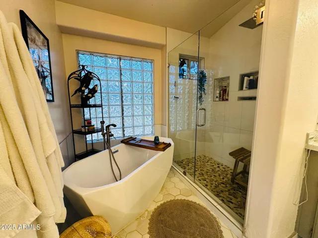 a bathroom with a tub and shower