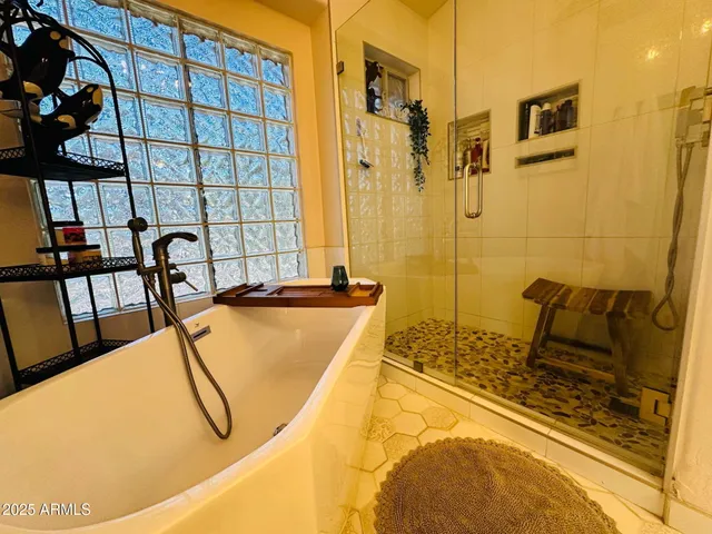 a bathroom with a tub and a shower