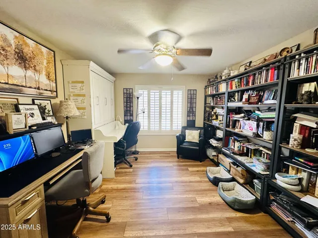 a living room with furniture and a book shelf