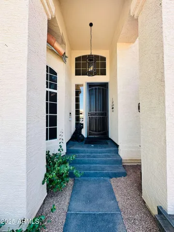 a view of a hallway with wooden floor and a window