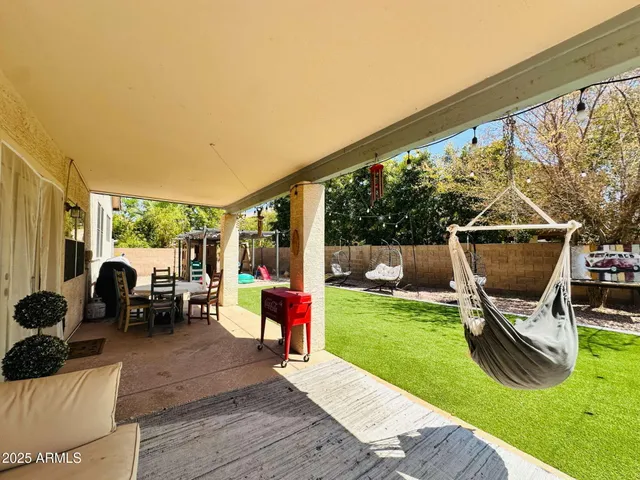 a view of a house with backyard and sitting area