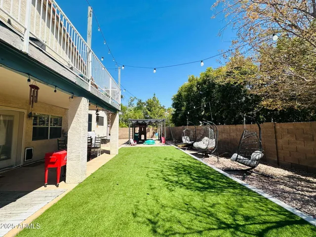 swimming view of a backyard with sitting area