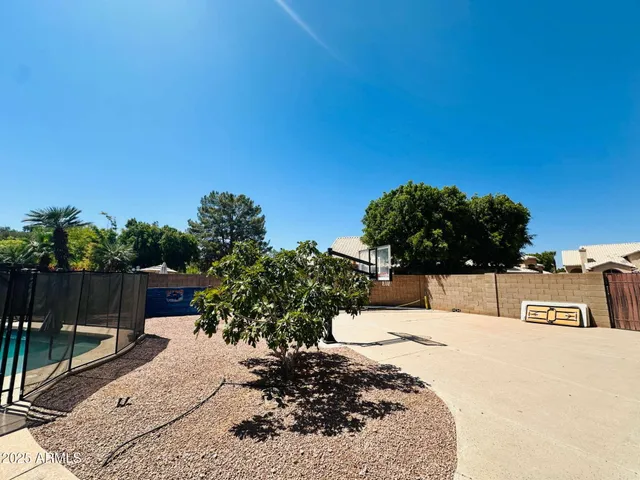 a backyard of a house with lots of green space and outdoor seating