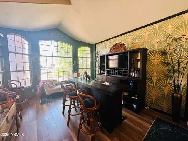 a view of a livingroom with furniture window and wooden floor