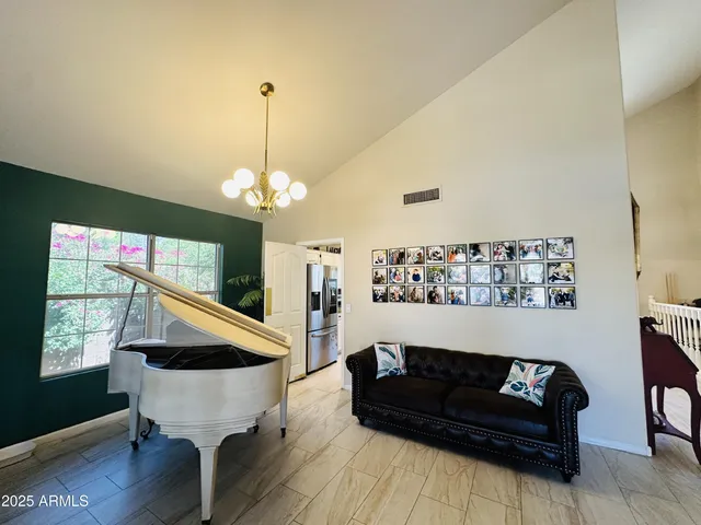 a living room with furniture and a chandelier
