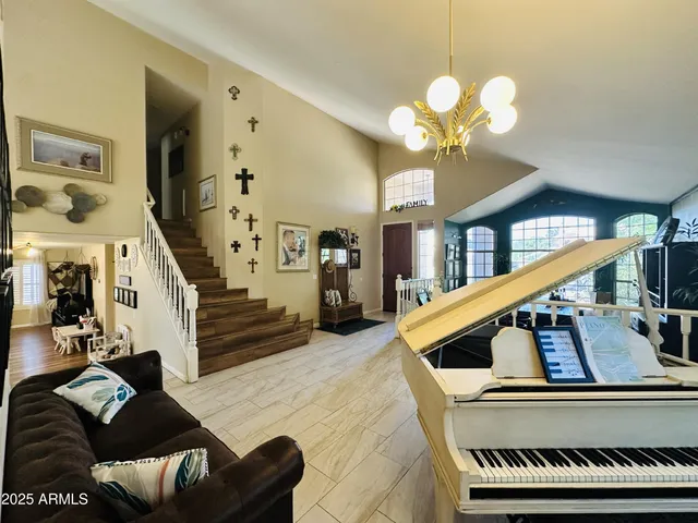 a living room with furniture fireplace and a chandelier