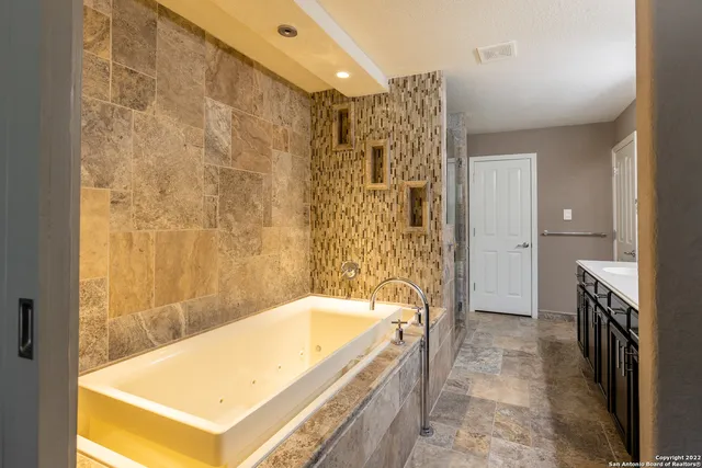 a en suite bathroom with a sink and a tub