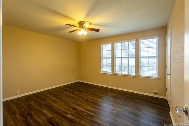 a view of walk in closet with wooden floor
