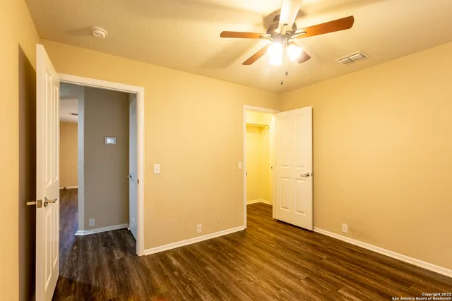 a view of a hallway with wooden floor and closet