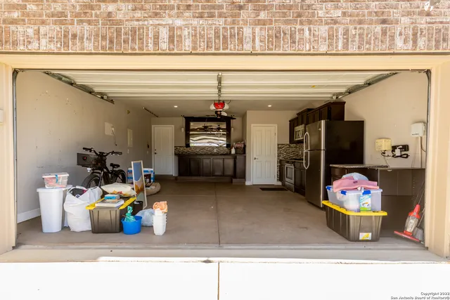 a kitchen with stainless steel appliances granite countertop a stove a sink dishwasher and a refrigerator