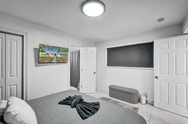 a bedroom with a bed and a lamp