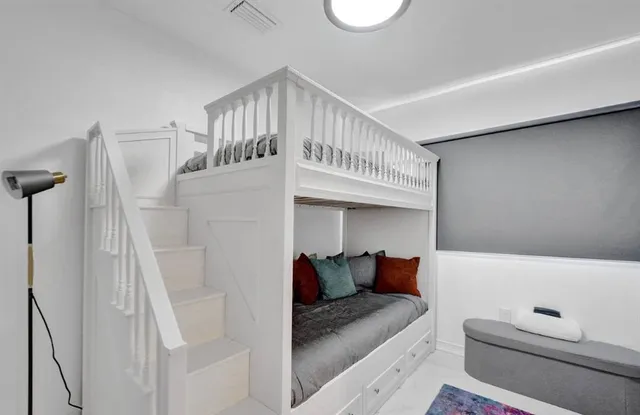 a view of bedroom with furniture and book shelf