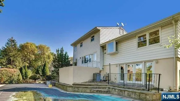 a view of a house with pool and sitting area