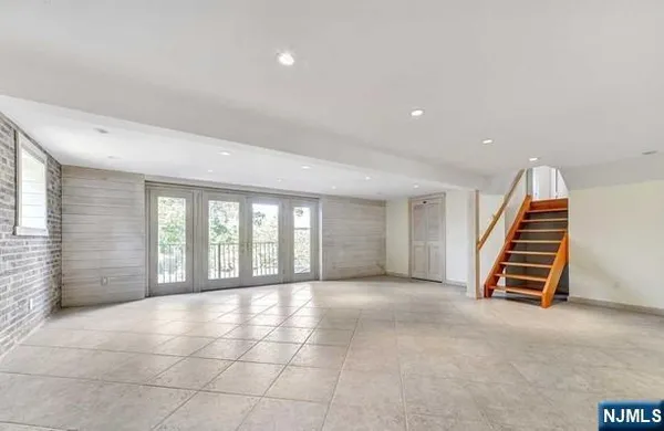 an empty room with windows and stairs