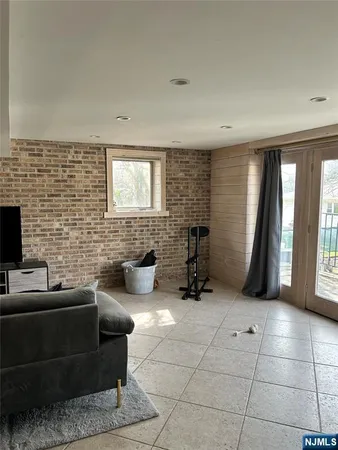 a living room with couches and a flat screen tv