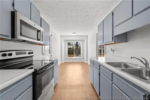 a kitchen with stainless steel appliances kitchen island a sink stove and cabinets