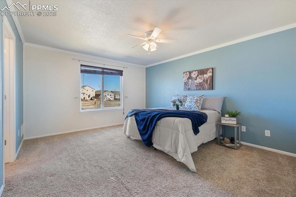 13038 Devil's Thumb Place Peyton, CO 80831 - Photo 14 of 44 The Primary Suite features a walk-in closet and an adjoining full bathroom with a dual-sink vanity and tub/shower combo.