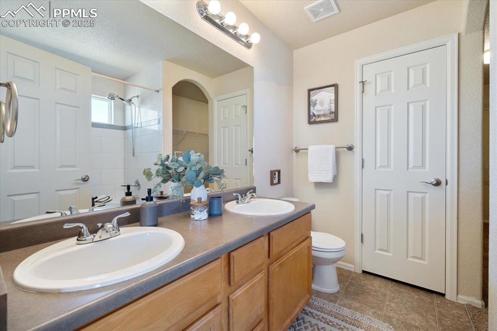 13038 Devil's Thumb Place Peyton, CO 80831 - Photo 17 of 44 The Primary Full Bathroom features a dual-sink vanity and tub/shower combo.
