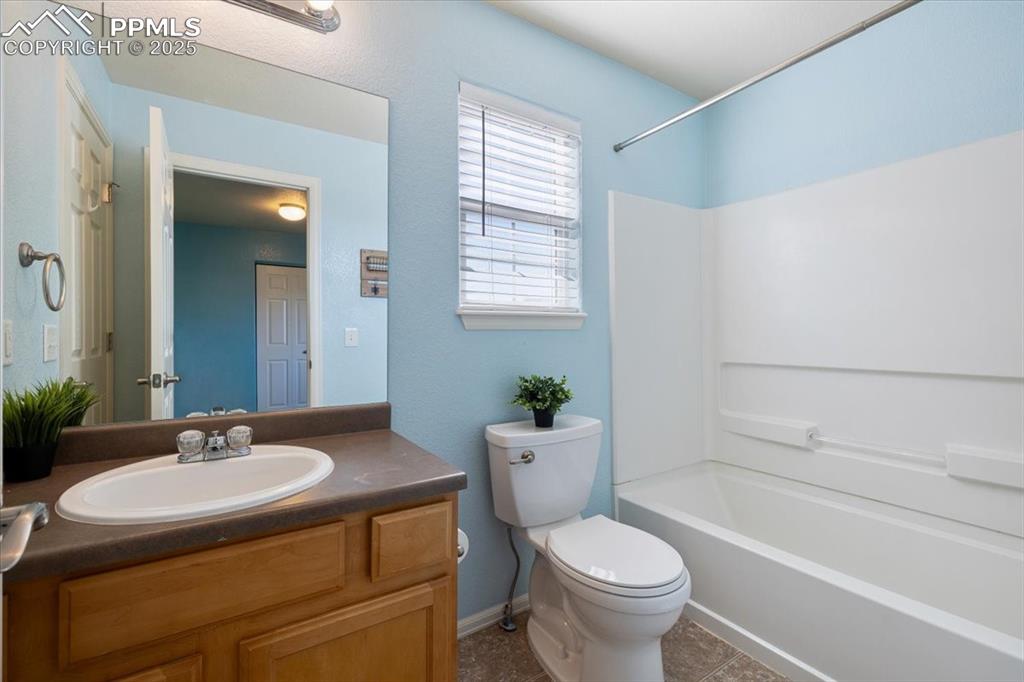 13038 Devil's Thumb Place Peyton, CO 80831 - Photo 26 of 44 Full Bathroom with vanity, mirror, and tub/shower.