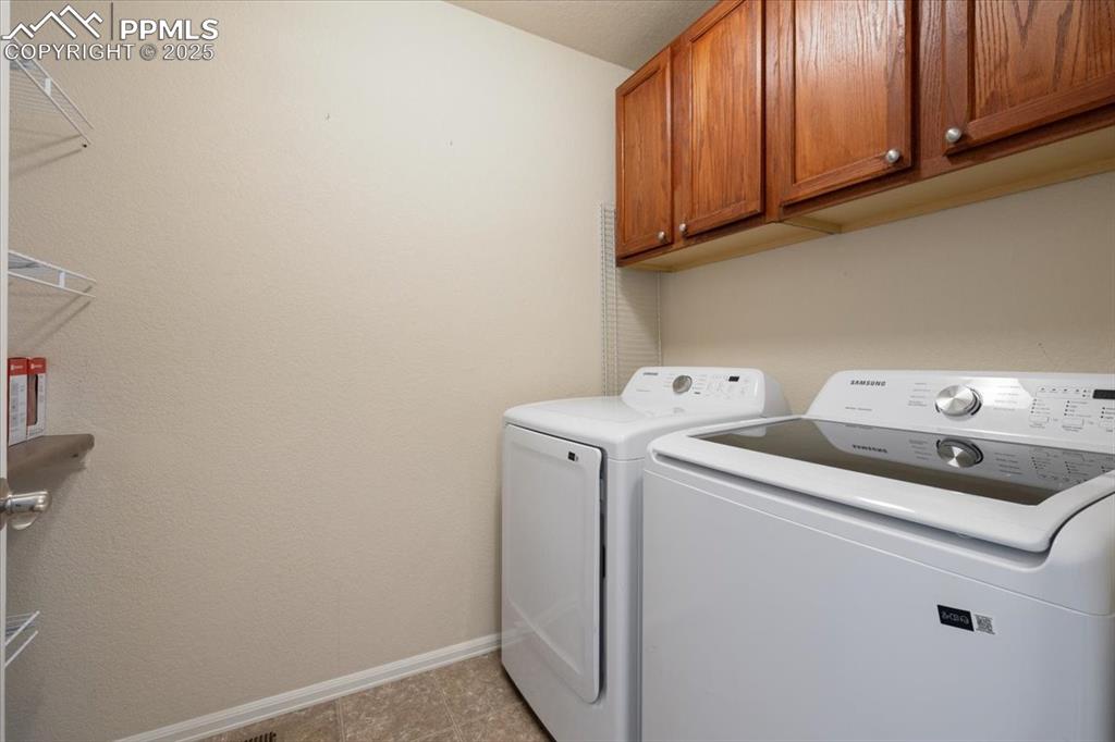13038 Devil's Thumb Place Peyton, CO 80831 - Photo 27 of 44 Laundry Room with upper cabinets and washer and dryer that stays.
