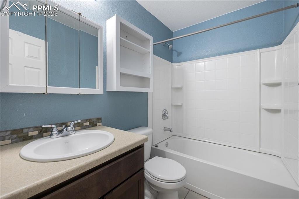13038 Devil's Thumb Place Peyton, CO 80831 - Photo 34 of 44 Basement Bathroom with vanity, mirrored medicine cabinet, and tub/shower.