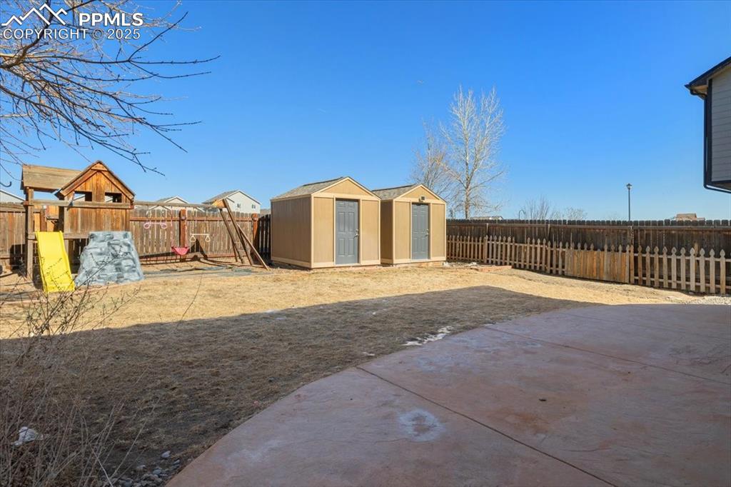 13038 Devil's Thumb Place Peyton, CO 80831 - Photo 35 of 44 Enjoy outdoor relaxation in the fenced backyard, which backs to open space and includes a stamped concrete patio & play set to enjoy outdoor dining and fun.